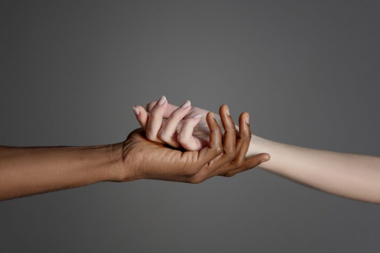 hands-of-interracial-couple-on-grey-background-2024-11-26-13-19-43-utc
